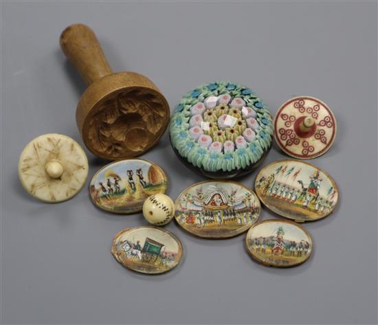 A collection of miniature glass paperweights, miniature dice, a cricket ball, two spinning tops and a butter pat etc